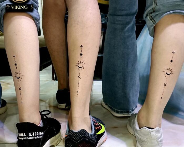 Three legs displaying matching small, simple brother and sister tattoos with celestial designs.