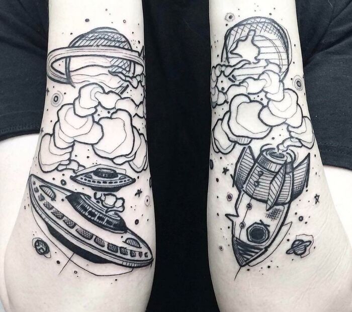 Space tattoos featuring planets, UFOs, and rockets in black ink on forearms.