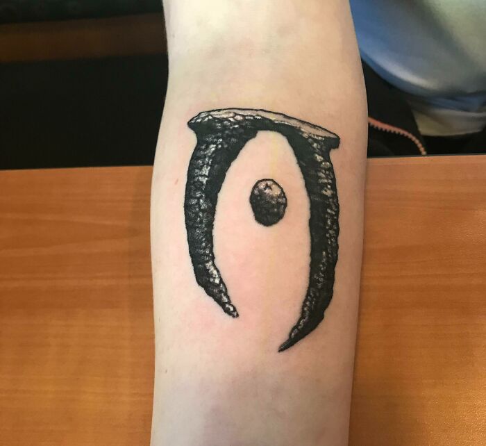 Oblivion video game tattoo featuring a dark, textured design on a person's forearm, symbolizing hardcore gaming dedication.