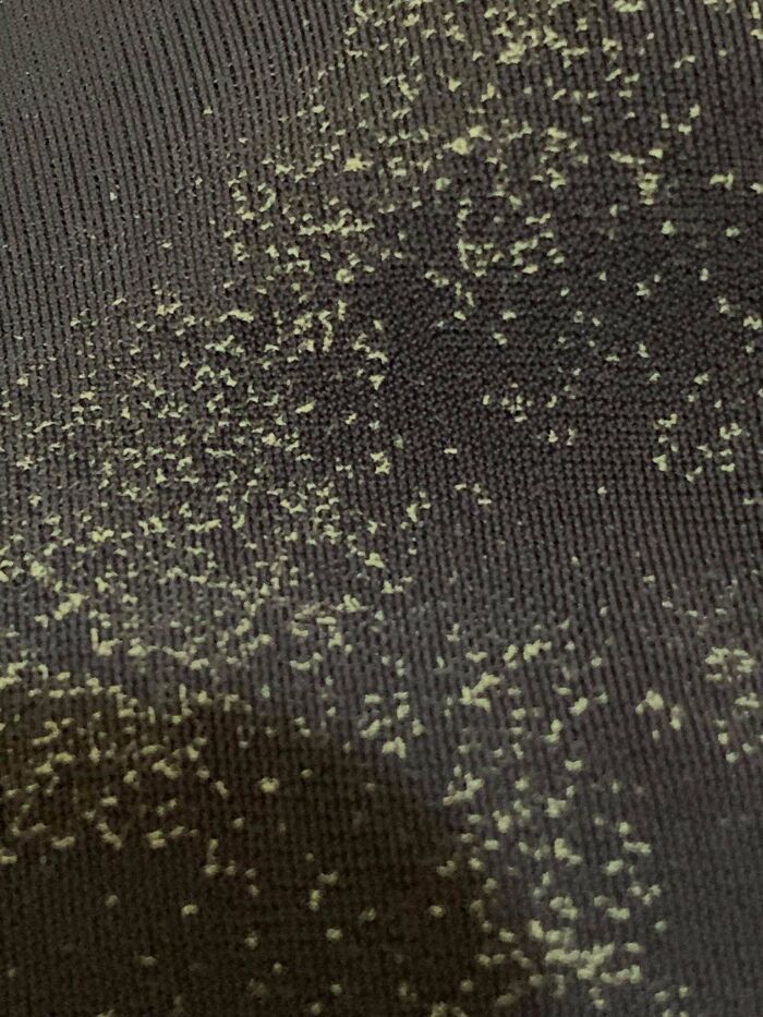 Close-up of a dark fabric with tiny scattered yellowish particles, illustrating mysterious objects found unexpectedly.