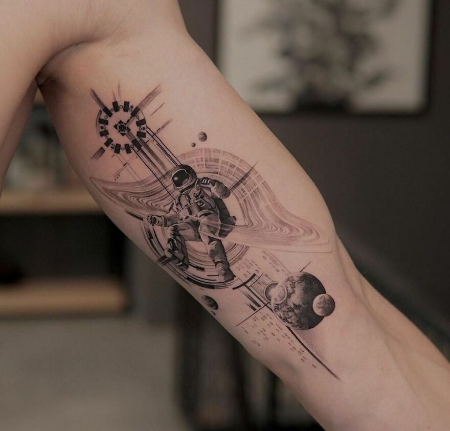 Astronaut tattoo design with planets and abstract elements, showcasing outer space cool.