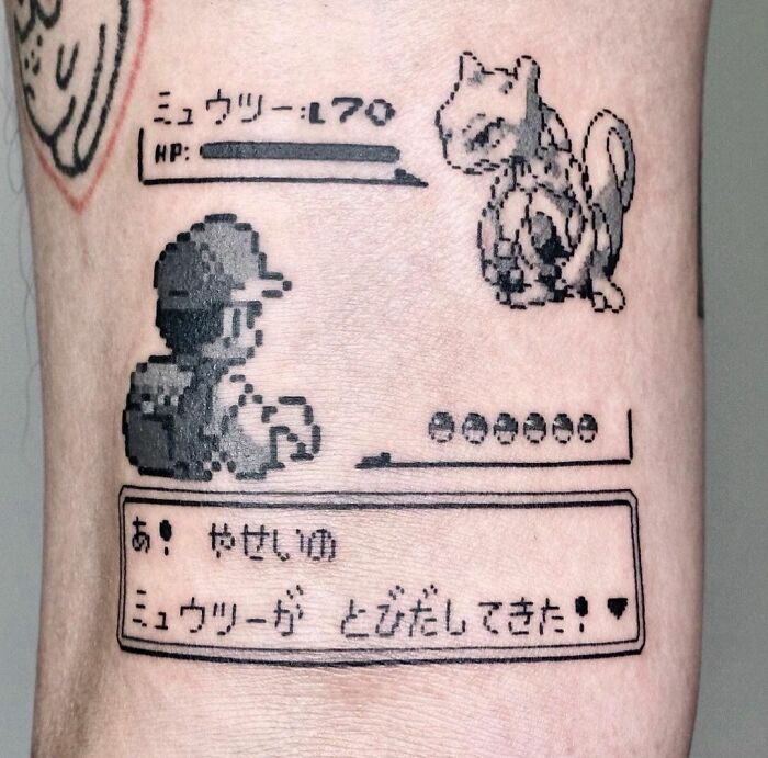 Pixelated Pokémon game screen tattoo featuring a video game battle with Japanese text, perfect for hardcore gamers.
