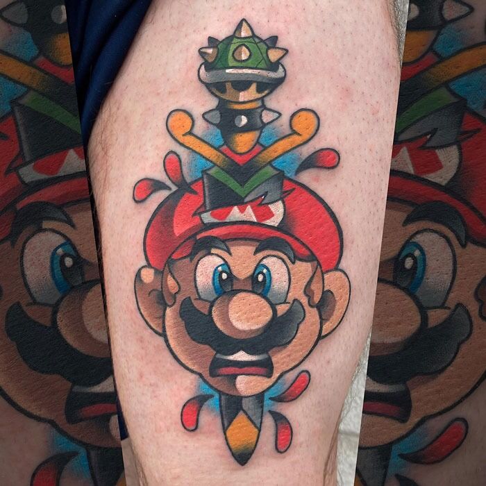 Colorful Mario video game tattoo featuring a famous plumber character with a spiked shell hat, ideal for hardcore gamers.