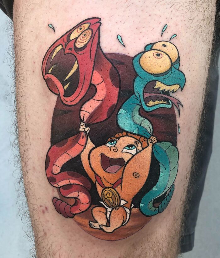 Hercules inspired cartoon tattoo of a smiling baby character lifting red and blue creatures, inspired by animated shows.