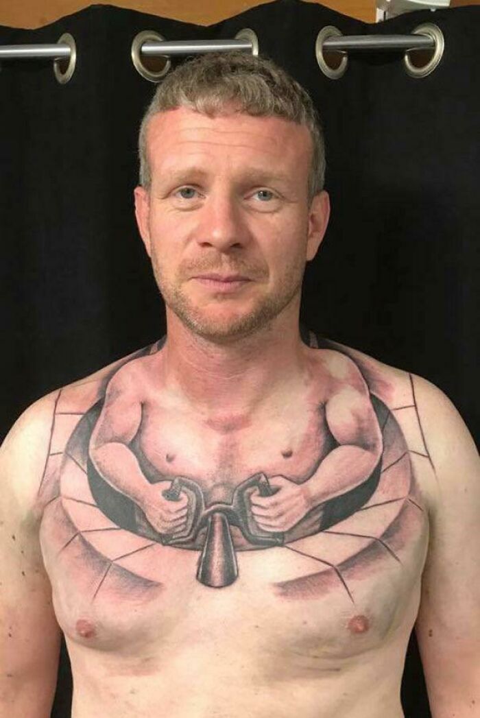 Man with an unusual tattoo design on his chest, which appears to depict a figure using a door knocker.