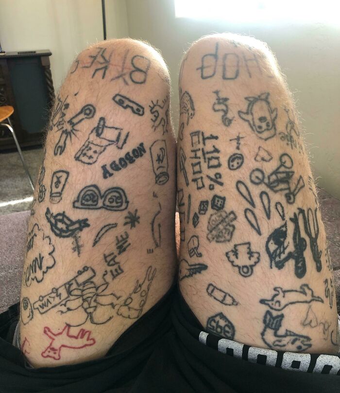 Unusual leg tattoos with various doodles and text, depicting the importance of researching tattoo artists.