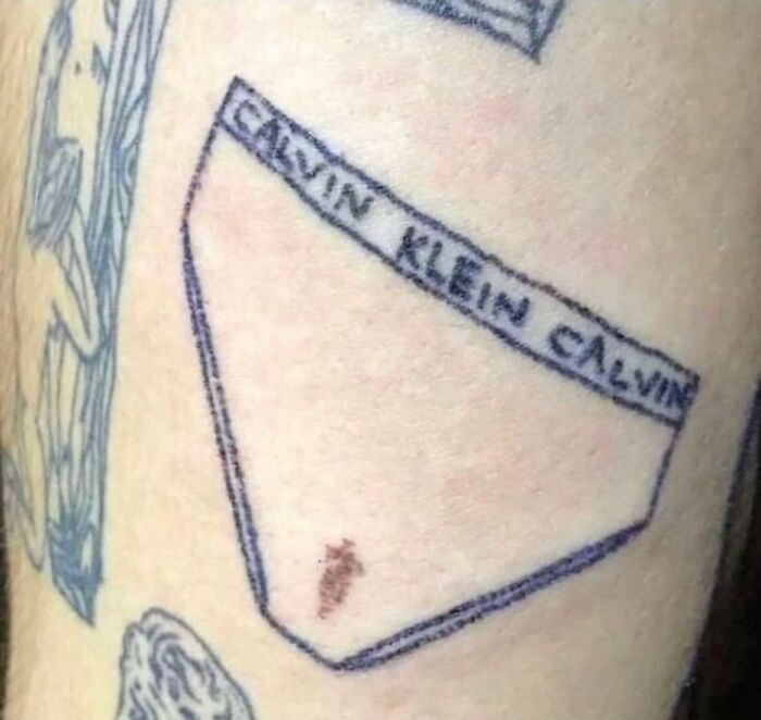 Poorly designed tattoo resembling Calvin Klein underwear on skin, illustrating tattoo artist research importance.