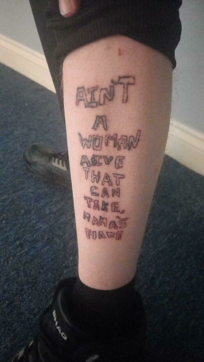 Tattoo fail with shaky text on leg, highlighting poor decision in choosing an artist for the tattoo.