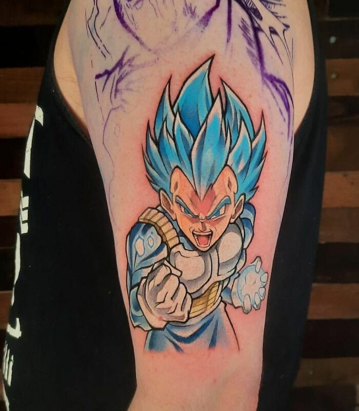 Cartoon tattoo of a fierce character with blue hair and armor on an arm, showcasing bold colors and dynamic design.
