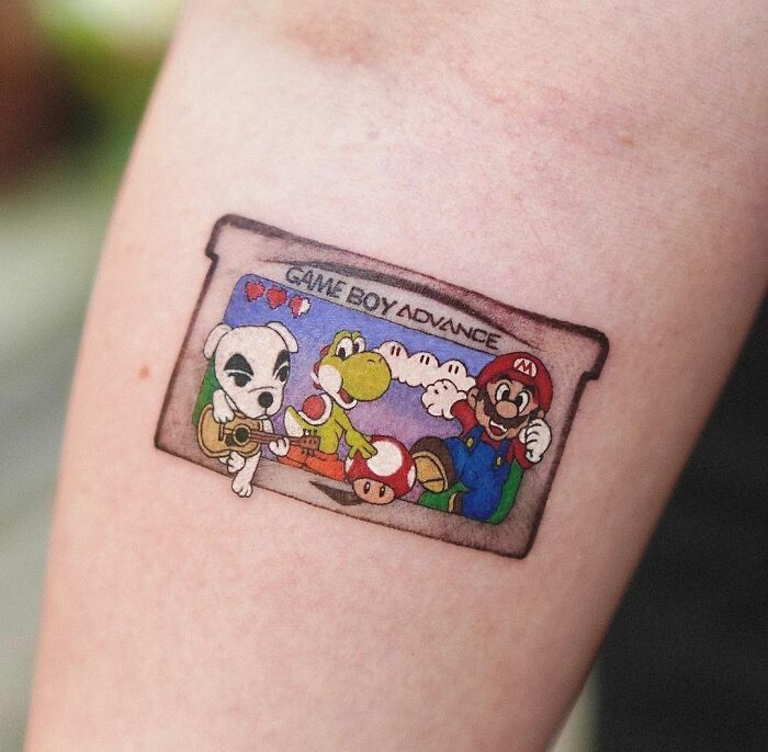 Game Boy Advance tattoo featuring popular video game characters on a gamer's arm.