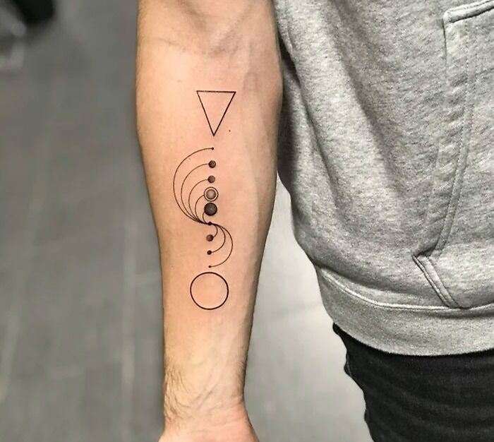 Destiny 2 game geometric tattoo on forearm, featuring circles and a triangle, ideal for video game fans.