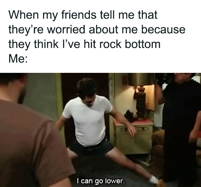Man humorously doing splits in a room with friends, captioned "I can go lower," illustrating relatable friendship memes.