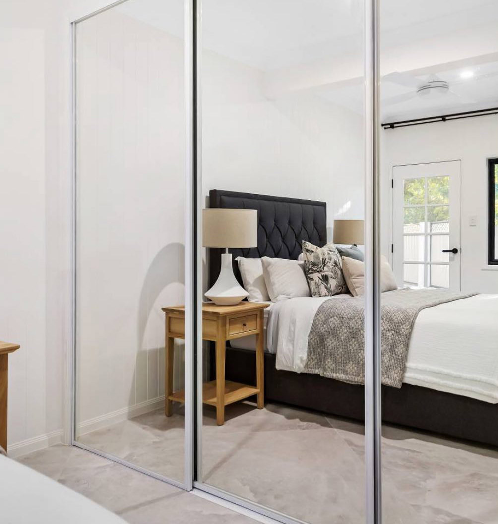 Ceiling-to-floor mirror bedroom wall