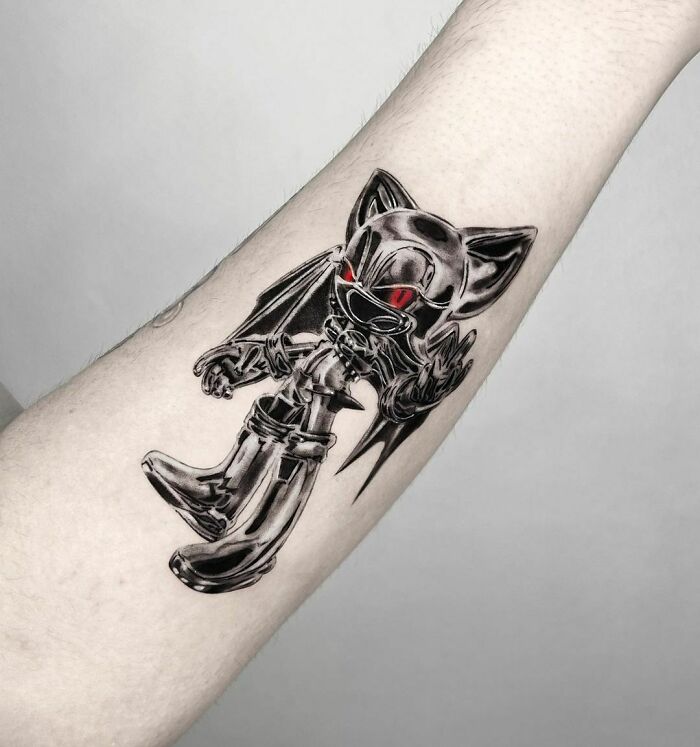 Video game tattoo depicting a chrome Sonic The Hedgehog character with red eyes on an arm.