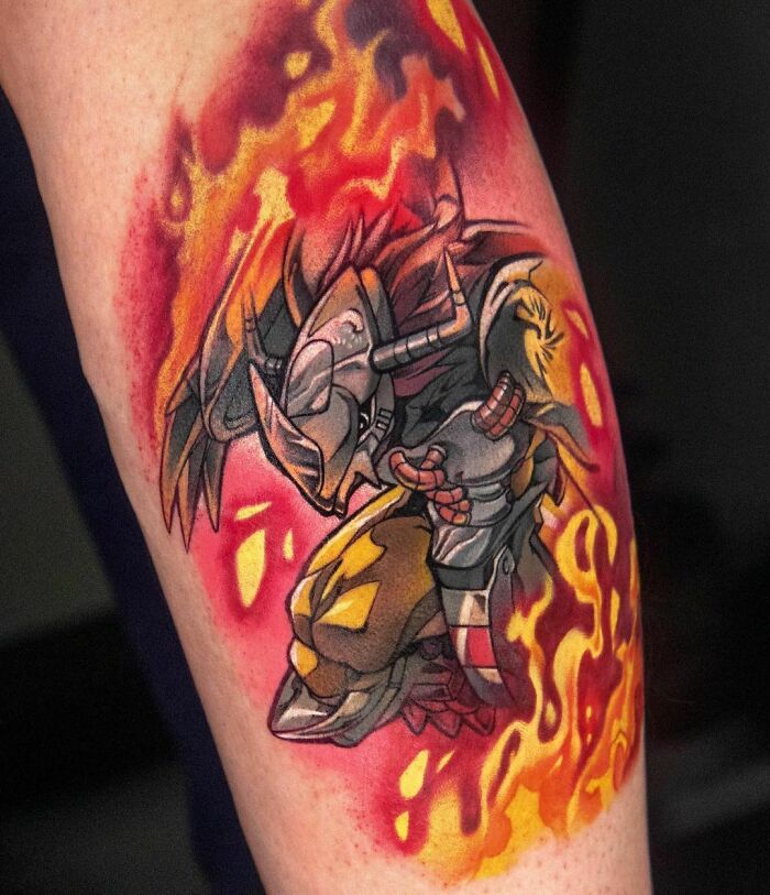 Colorful Digimon Masters video game tattoo featuring fiery armored character on a forearm, perfect for hardcore gamers.