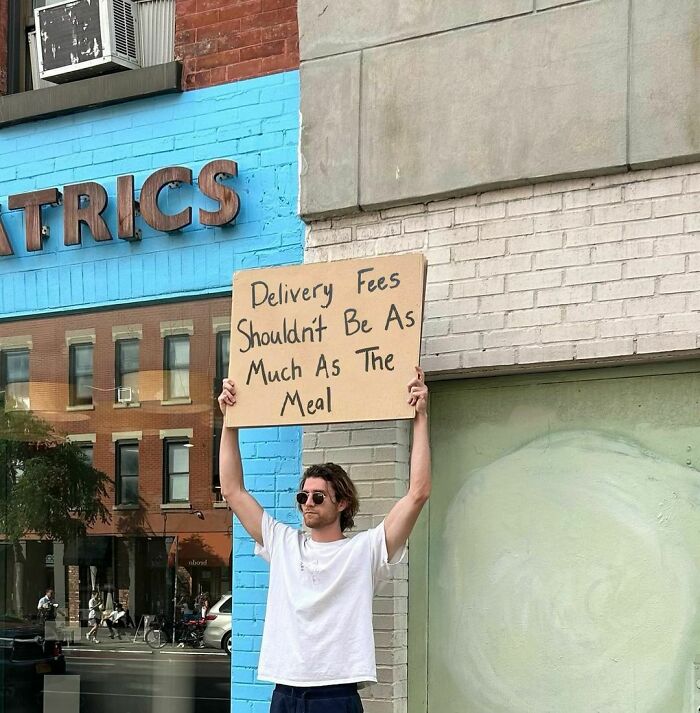 Clever-Dude-With-Sign-Protesting-Annoying-Things