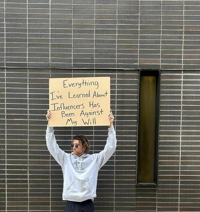 Clever-Dude-With-Sign-Protesting-Annoying-Things