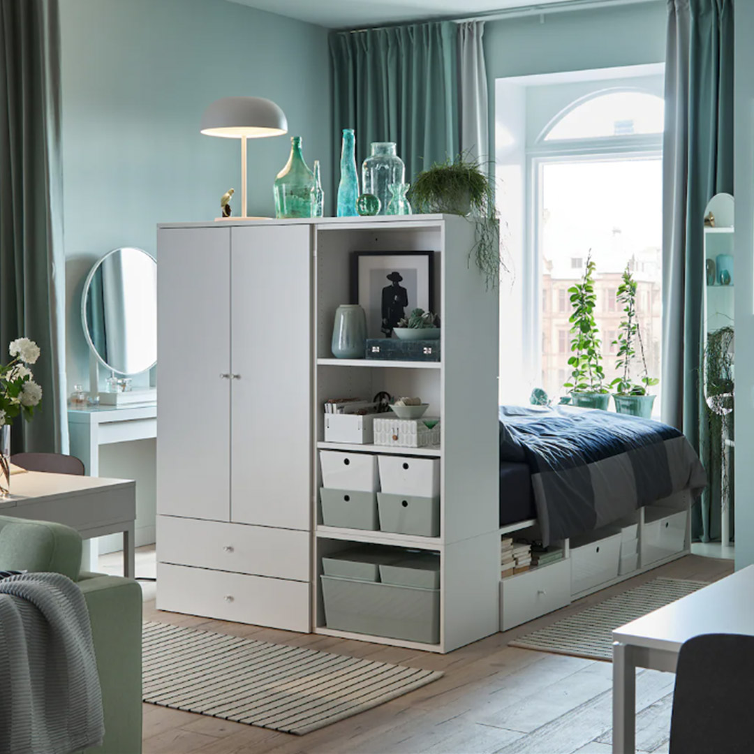 White headboard/closet room divider with things inside and on top of it White headboard/closet room divider with things inside and on top of it