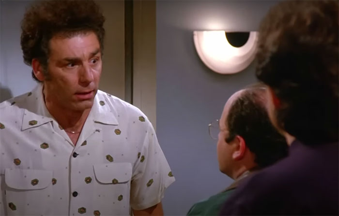 Cosmo Kramer wearing a gray shirt, captured in a classic Seinfeld scene featuring funniest quotes about everyday life.