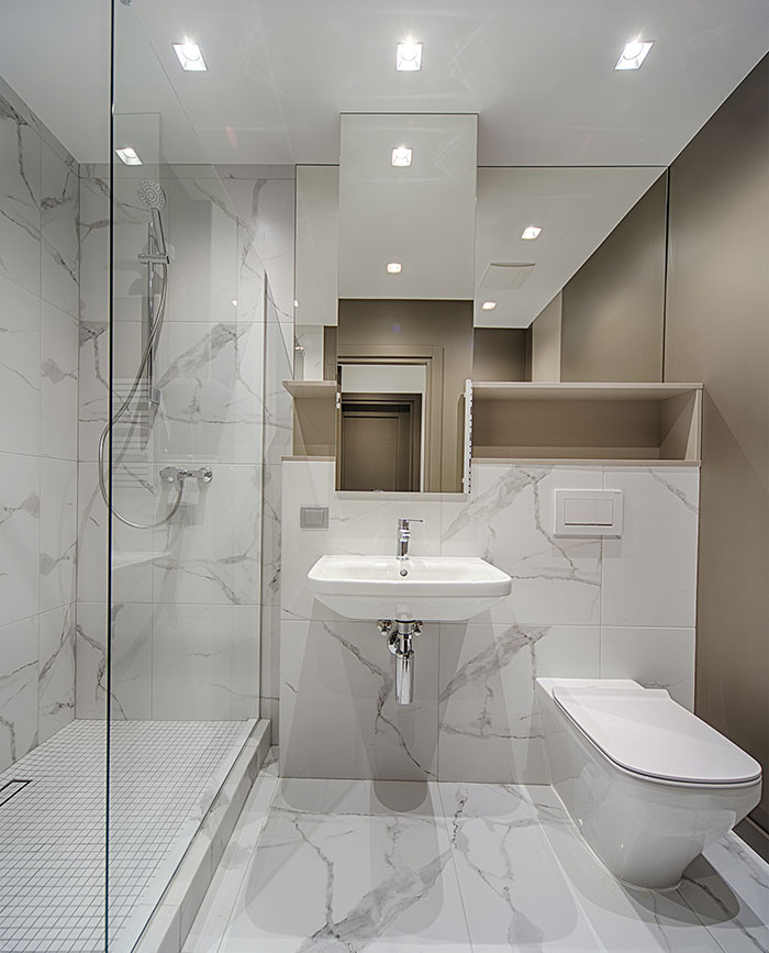 All White Bathroom With Marbled Floor And Walls All White Bathroom With Marbled Floor And Walls
