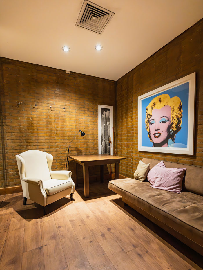 Modern brick wall room design with a painting on the wall Modern brick wall room design with a painting on the wall