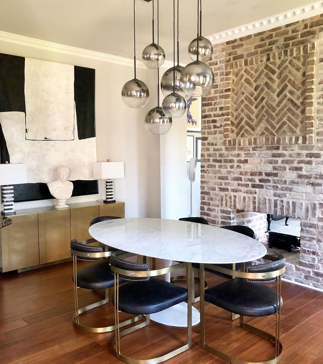 Dining room with a brick wall and fireplace inside it Dining room with a brick wall and fireplace inside it