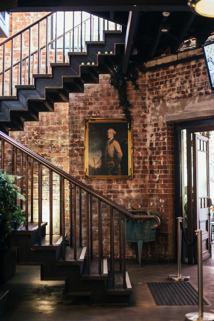 Brick wall and classic staircase design Brick wall and classic staircase design