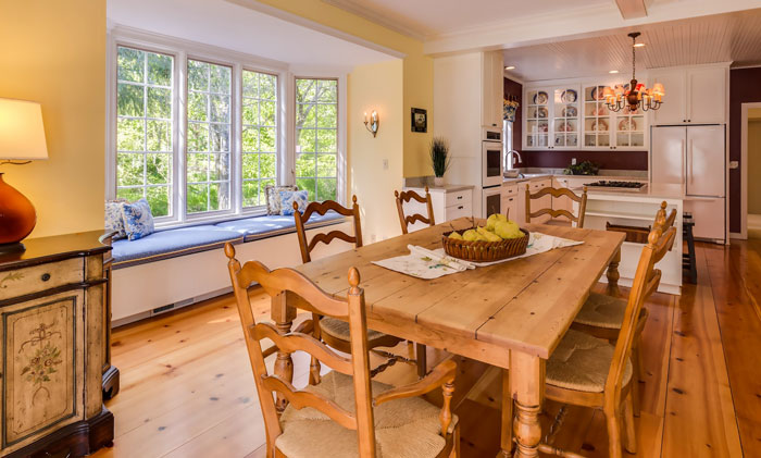 Wooden farmhouse living room with wooden table and kitchen Wooden farmhouse living room with wooden table and kitchen