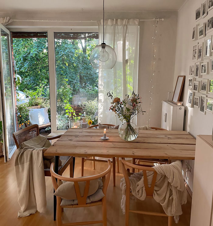 Farmhouse room with wooden table chairs and white interior Farmhouse room with wooden table chairs and white interior
