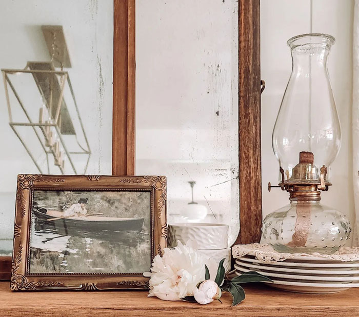 Brown wooden cupboard with old lamp flower and picture Brown wooden cupboard with old lamp flower and picture
