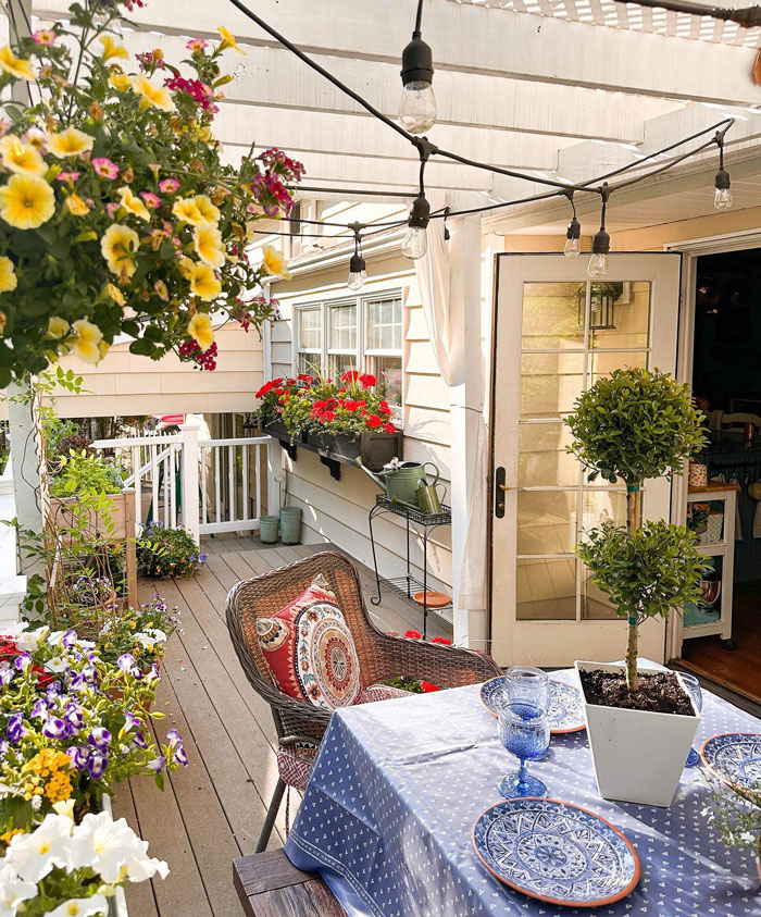 Porch with flowers table with blue sheets Porch with flowers table with blue sheets
