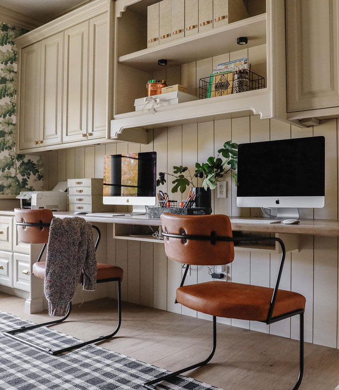 Work room with white cupboards computer rug and table with chairs Work room with white cupboards computer rug and table with chairs