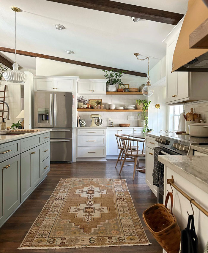 Kitchen with creamy cupboards striped rug and dishes Kitchen with creamy cupboards striped rug and dishes