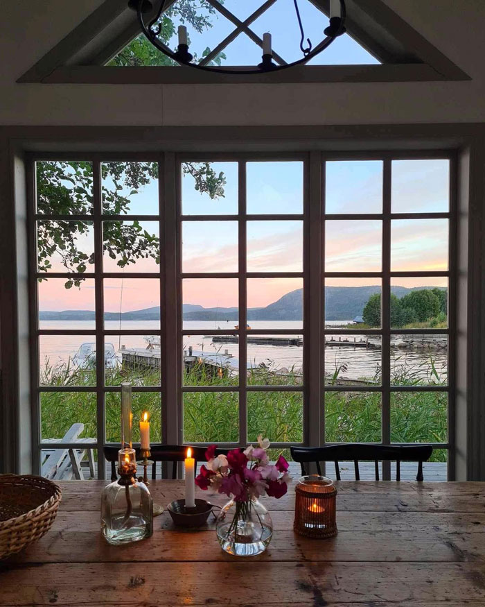 Wooden table with lighted candles and window Wooden table with lighted candles and window