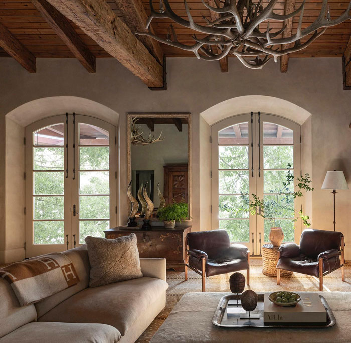 Country style living room with creamy sofa table and leather chairs Country style living room with creamy sofa table and leather chairs