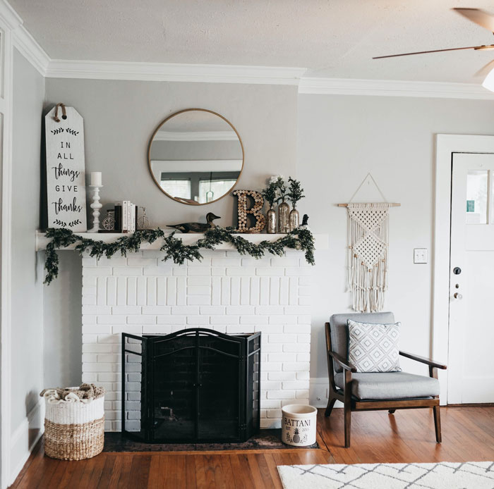 white fireplace mantel with decors and wooden floor white fireplace mantel with decors and wooden floor