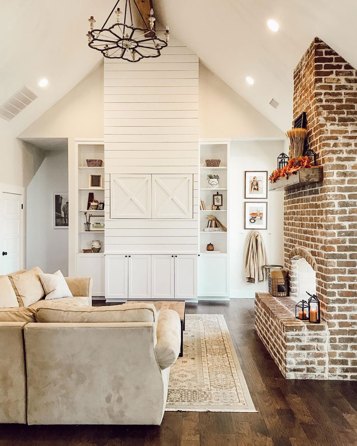 Farmhouse living room with sofa paintings and cupboard Farmhouse living room with sofa paintings and cupboard