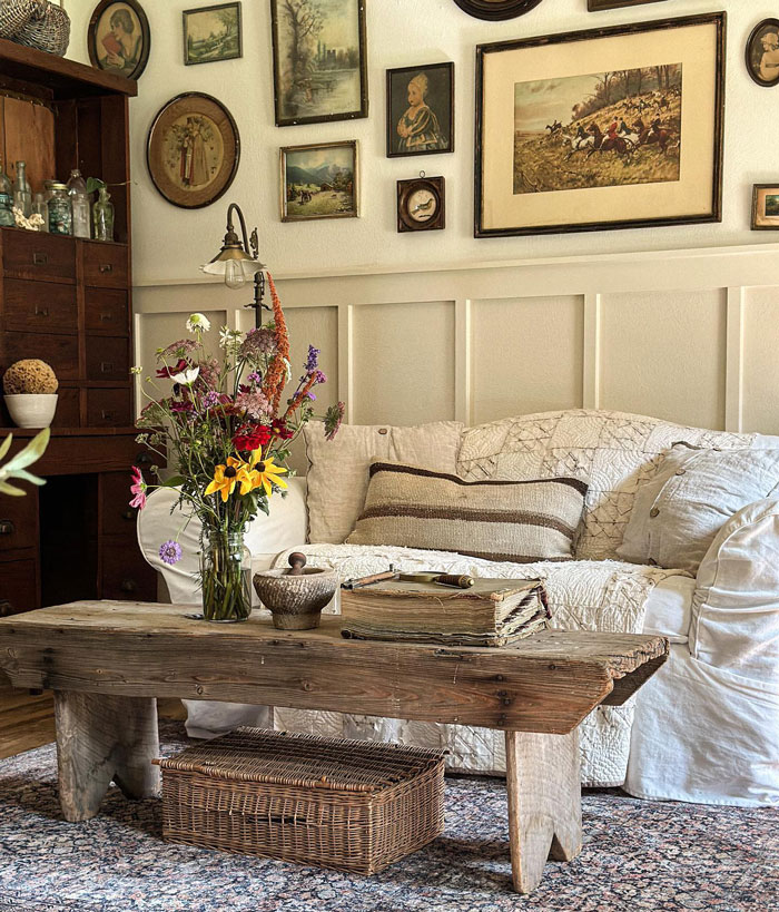 Room with old table sofa with white sheets and pillows and flowers Room with old table sofa with white sheets and pillows and flowers