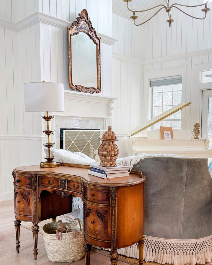 White room with brown cupboard with lamp and mirror White room with brown cupboard with lamp and mirror