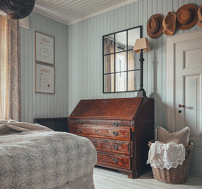 Room with old furniture rug and bed with gray sheet Room with old furniture rug and bed with gray sheet