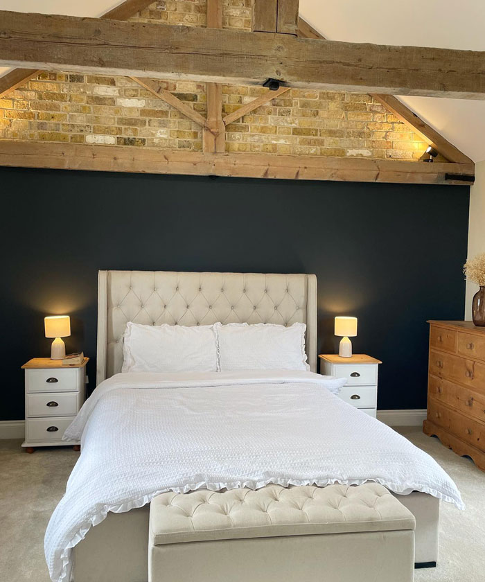 Bed in attic with white sheets and white pillows Bed in attic with white sheets and white pillows