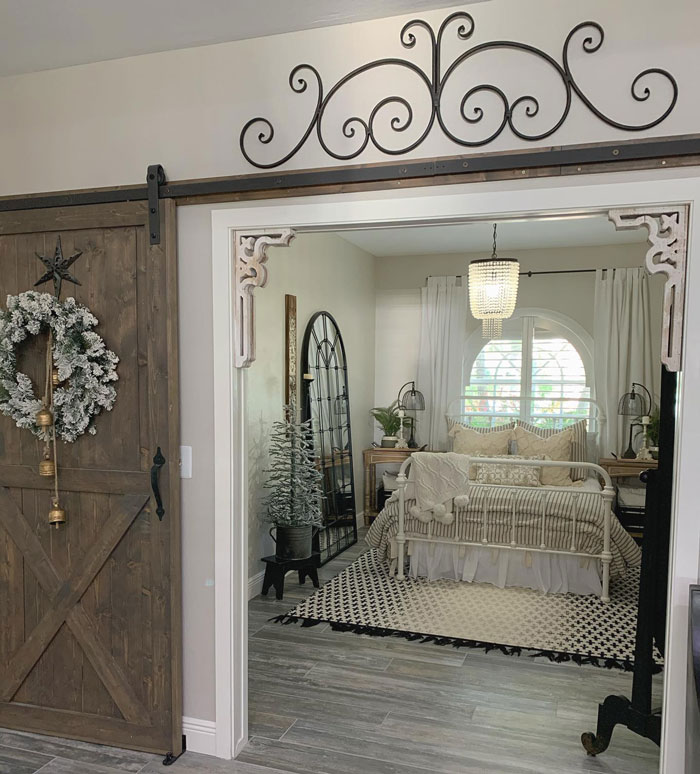 Room with bed with gray sheets and big mirror Room with bed with gray sheets and big mirror