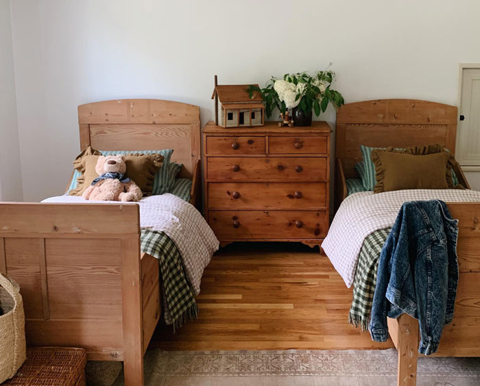 Room with separate beds with stripped green sheets and cupboard Room with separate beds with stripped green sheets and cupboard