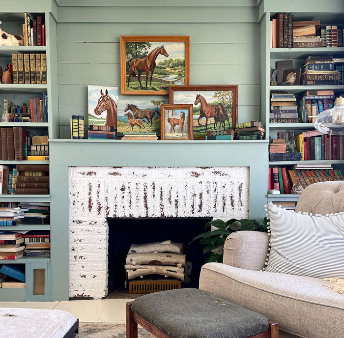 Room with fireplace horse paintings and sofa Room with fireplace horse paintings and sofa