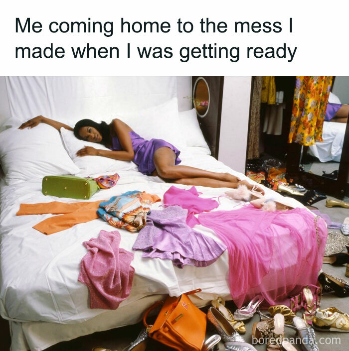 Woman in purple dress lying on a messy bed with clothes and shoes scattered around.