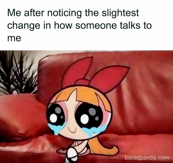 Cartoon character sitting on a red couch with teary eyes, capturing a funny meme about women.