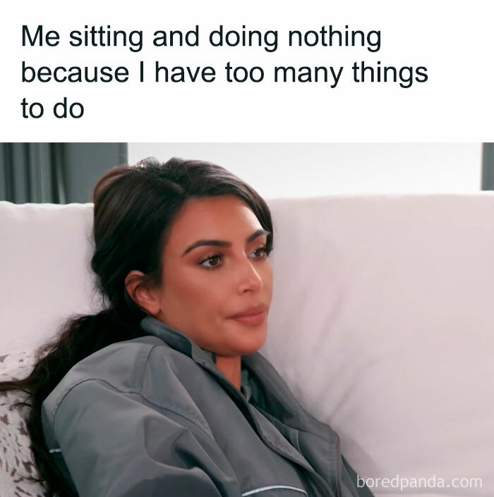 Woman in a robe sitting on a couch with a neutral expression, meme text above about procrastination and too many things to do.