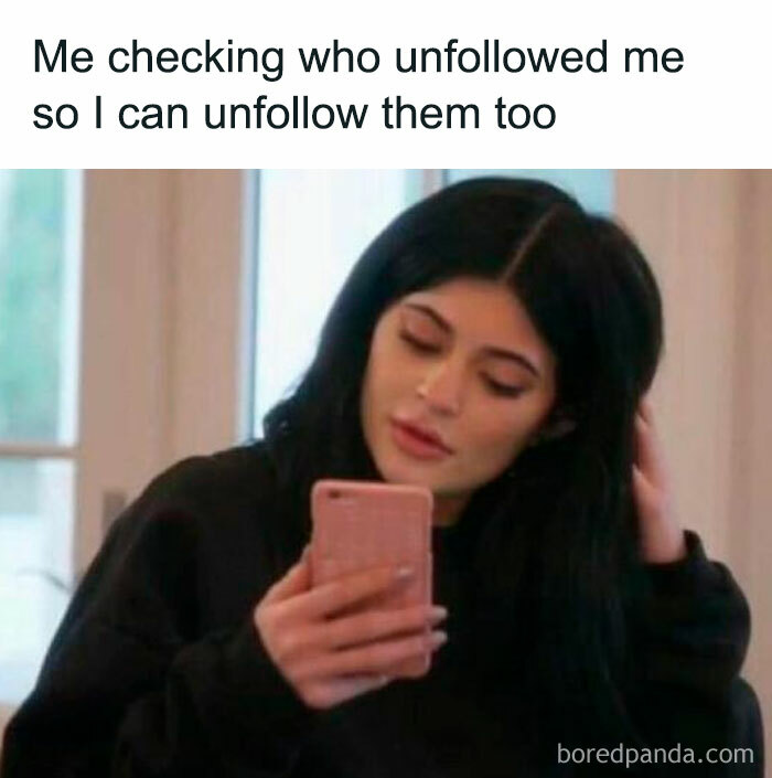 Woman checking her phone with a funny meme text about unfollowing on social media.