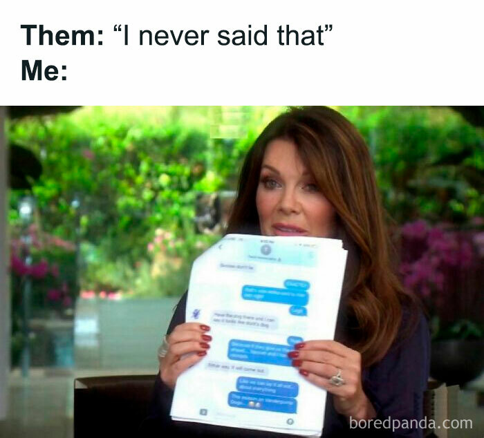Woman humorously holding phone screenshot, text on image says 'Them: I never said that'.
