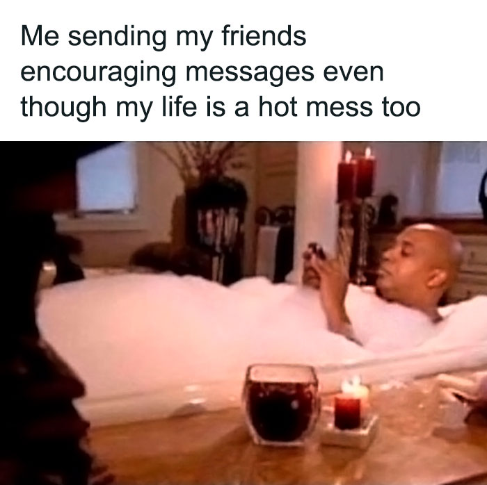 Person in a bubble bath texting, meme about relatable friendship moments, candles and drink on the table.